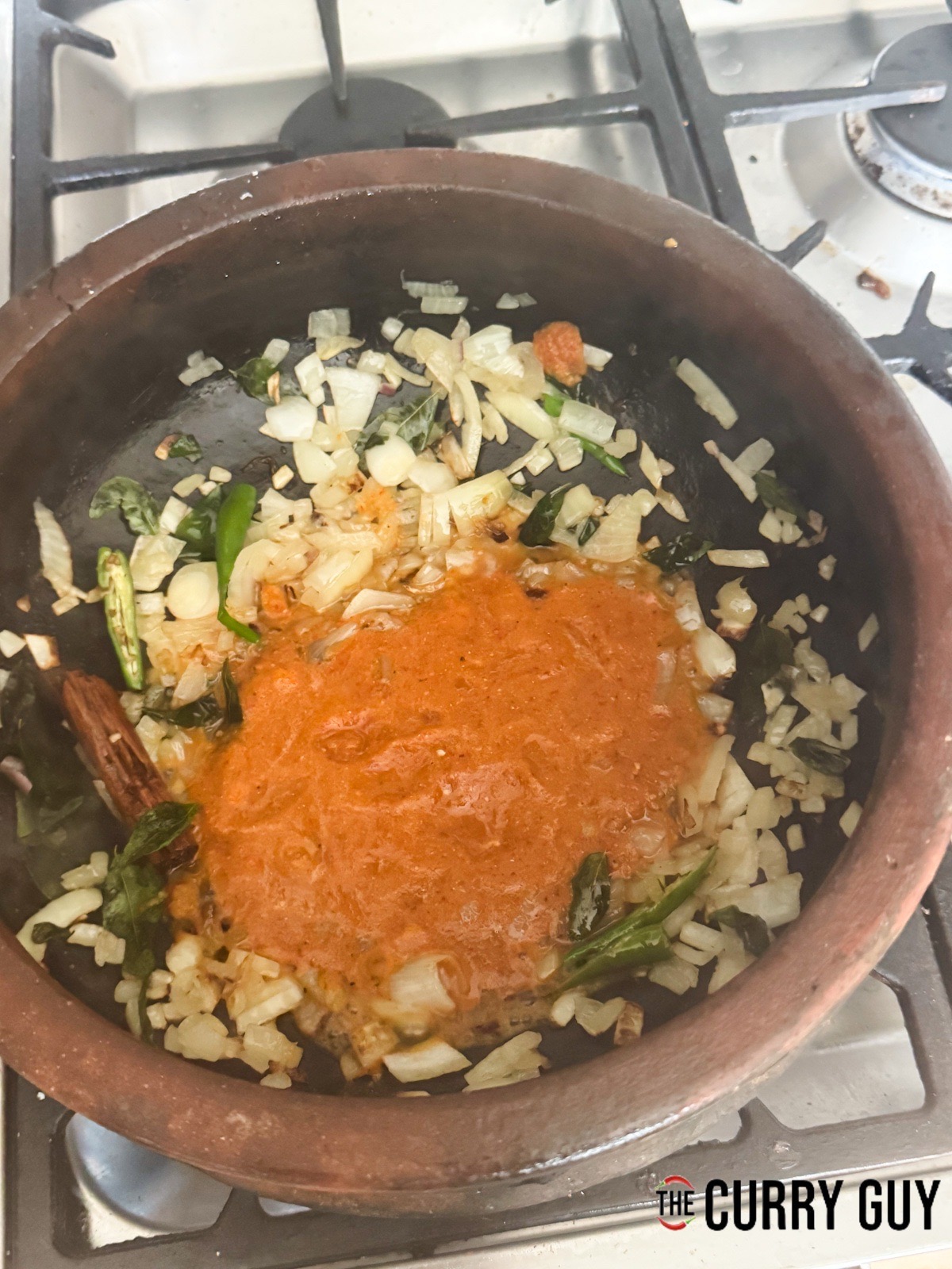 Stirring in the curry paste.