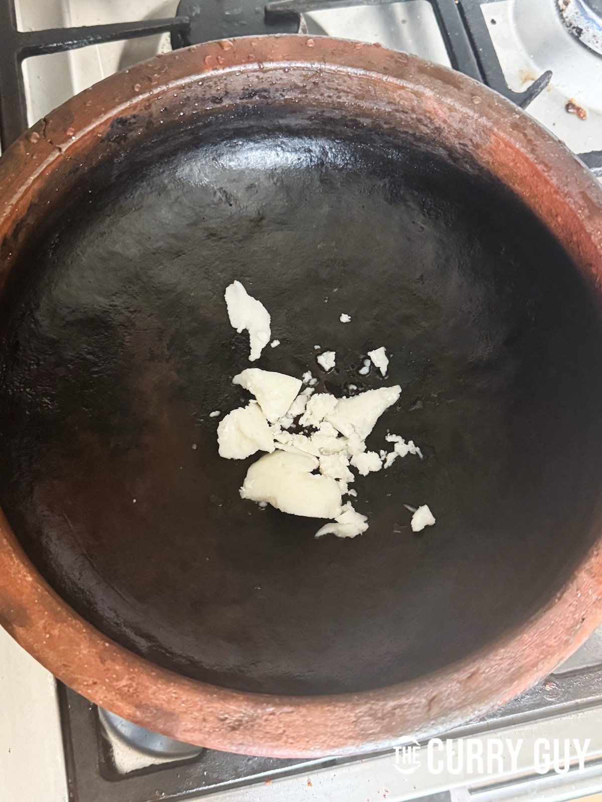 Melting the coconut oil in the pot.