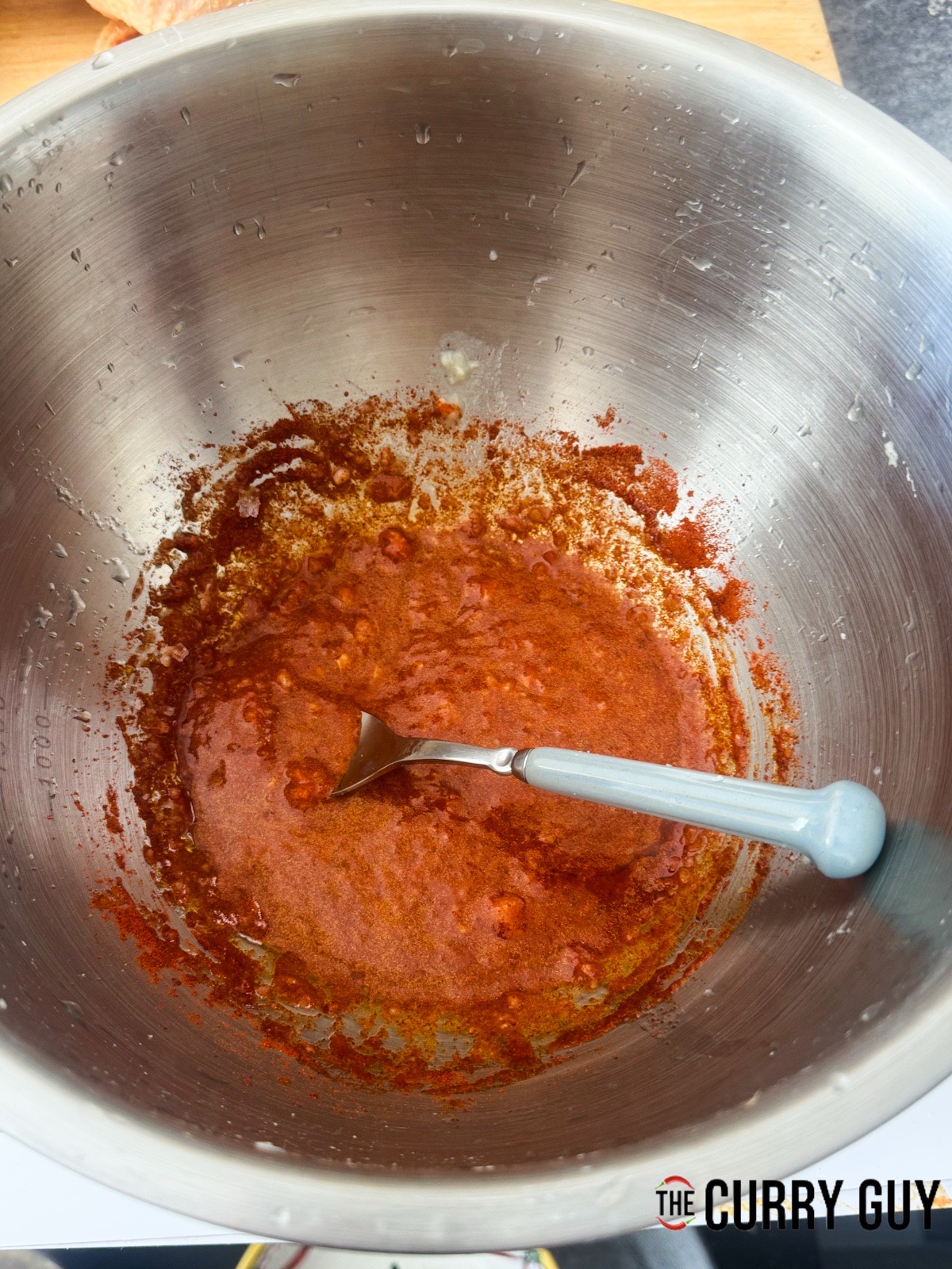 Whisking the ingredients for the first marinade together in a mixing bowl.