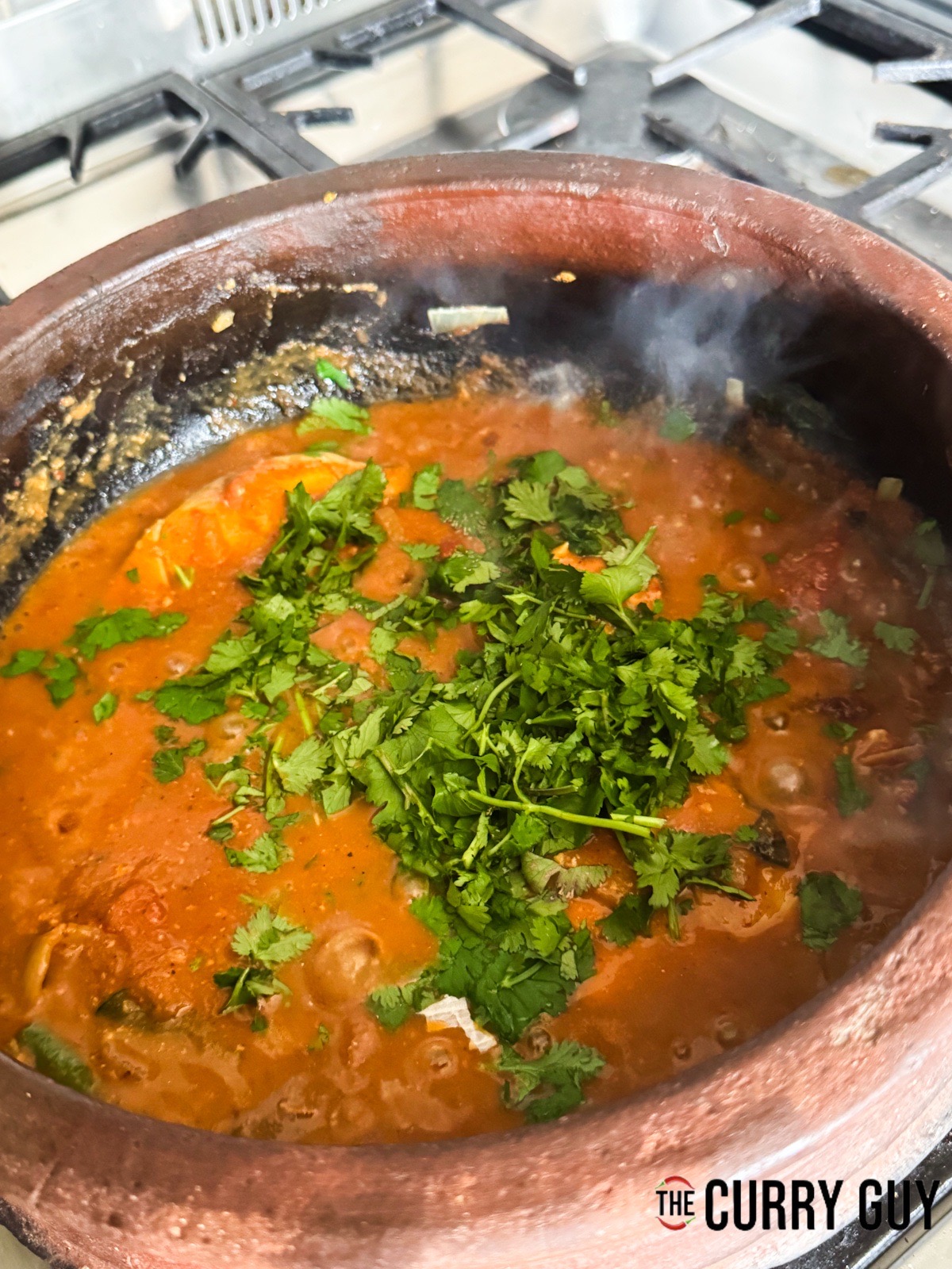 Adding chopped coriander and seasoning with salt to taste