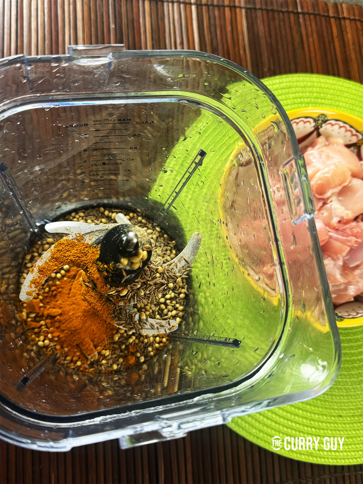 The spices in a spice grinder ready to grind to a powder.
