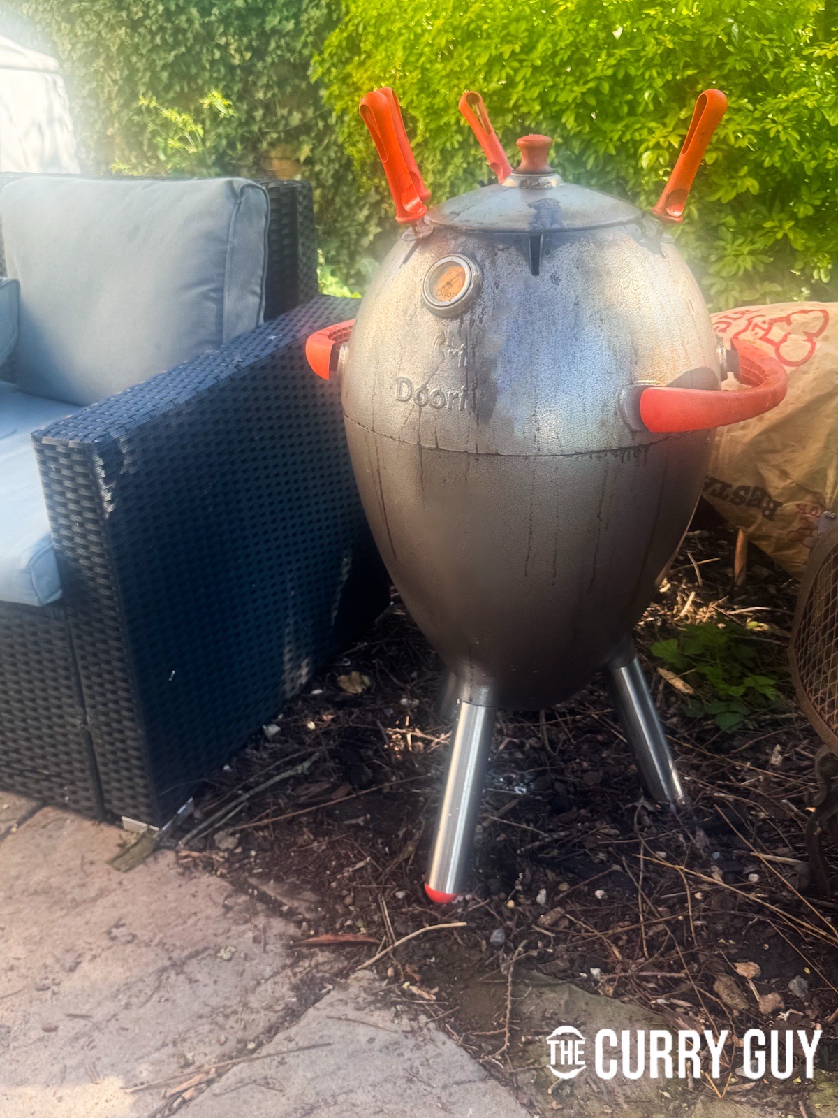 Covering the tandoori to let the chickens cook.