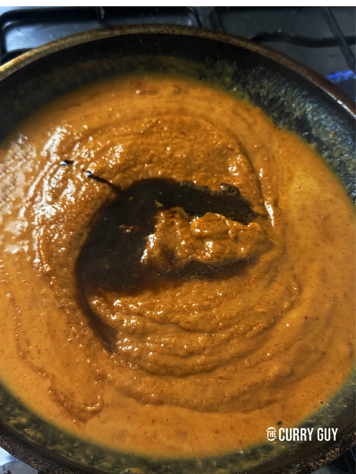 Stirring in tamarind water, lime juice and fish sauce to the peanut sauce.