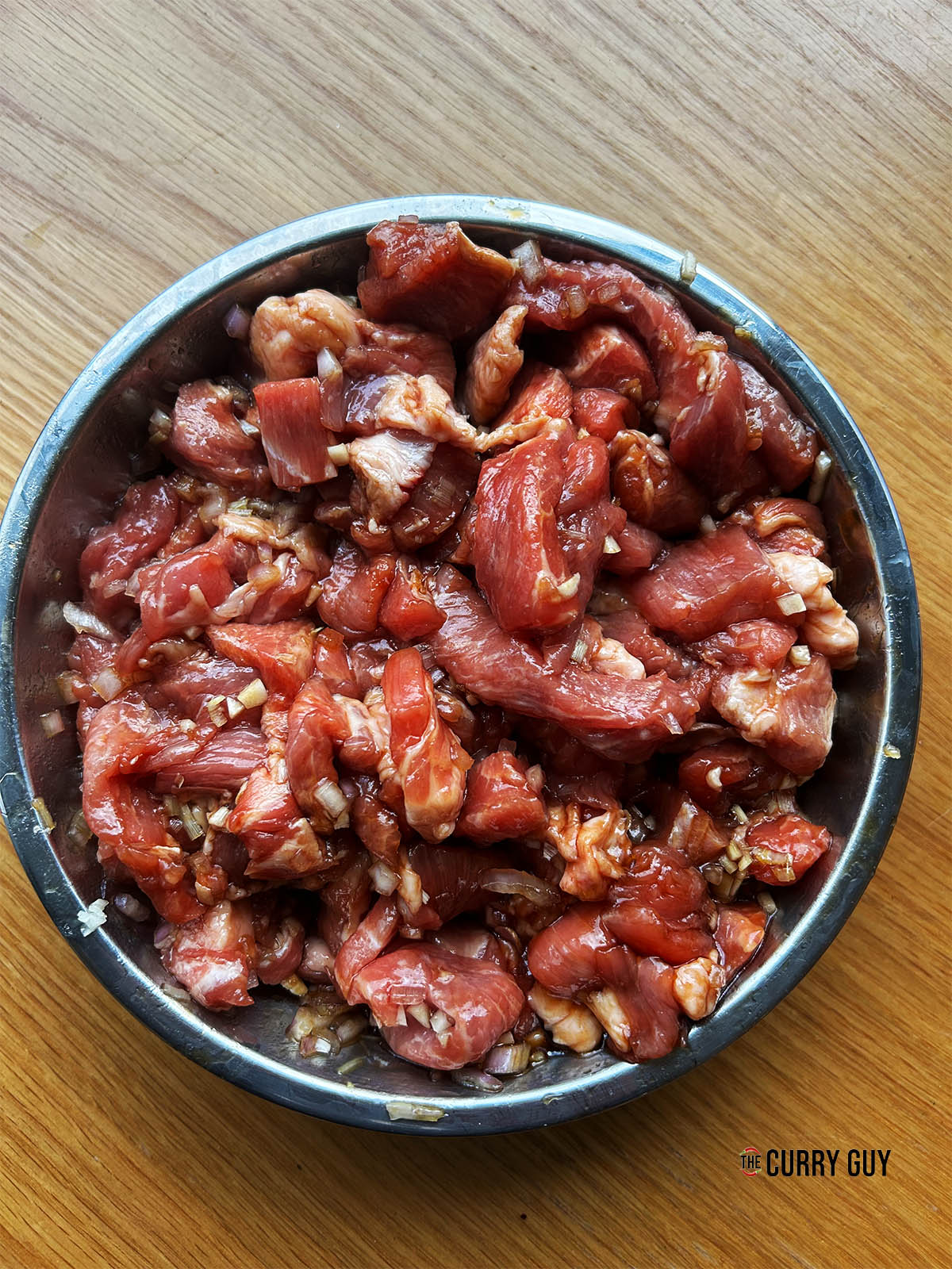 The pork mixed in with the marinade ingredients to marinate for a few hours.