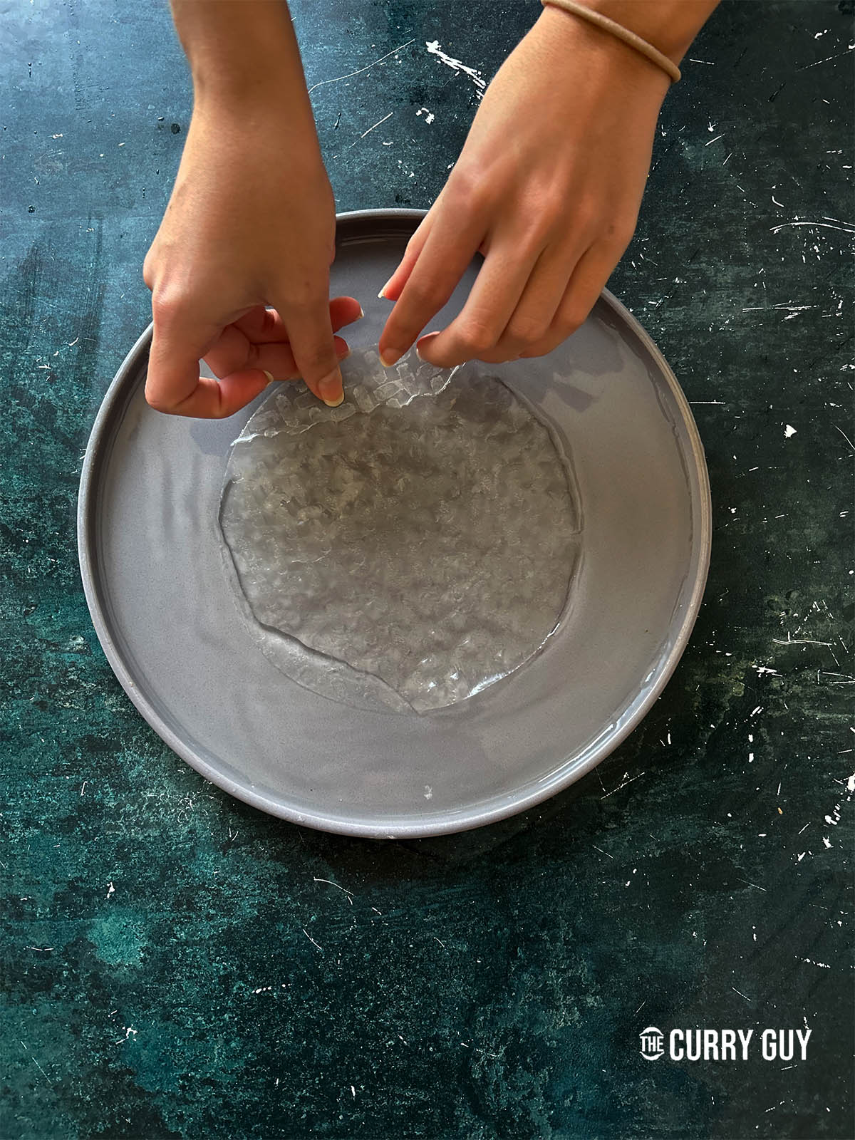Soaking a piece of rice paper in water.