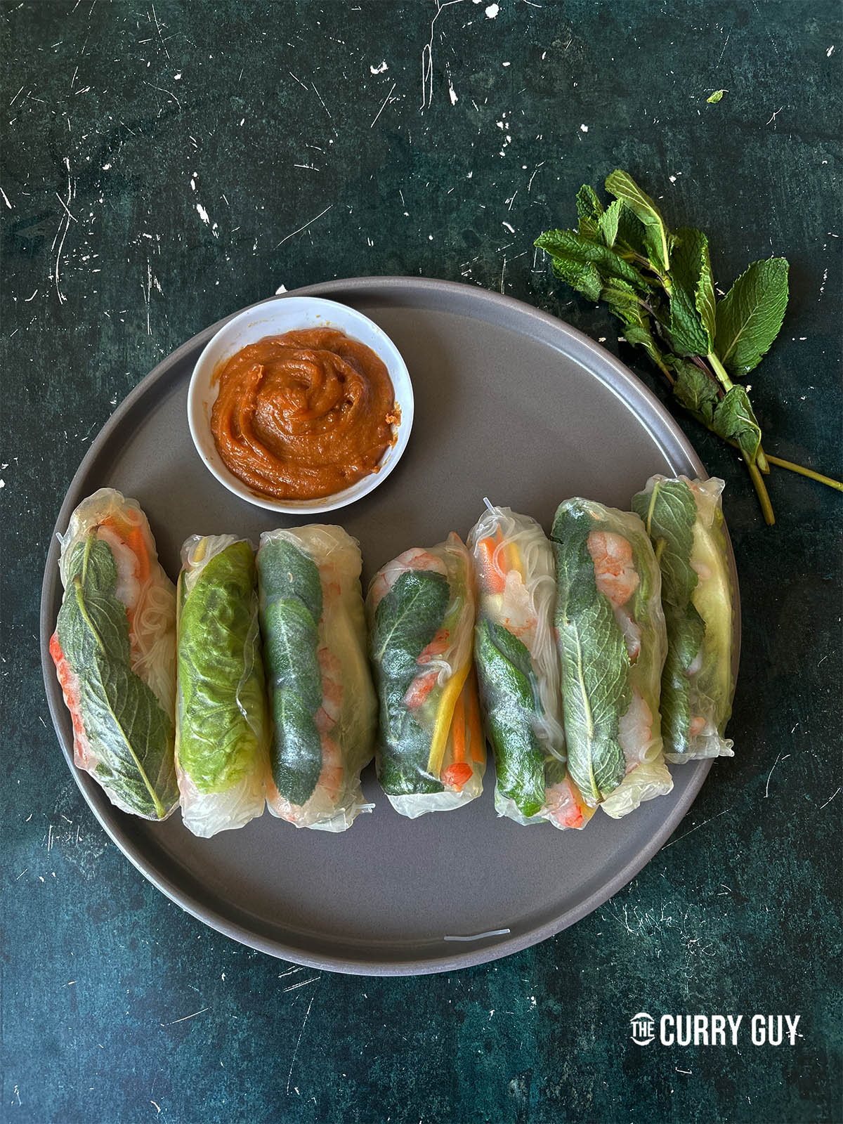 Finished summer rolls ready to serve with peanut sauce.