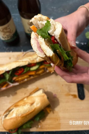 Picking up a tofu banh me to eat.