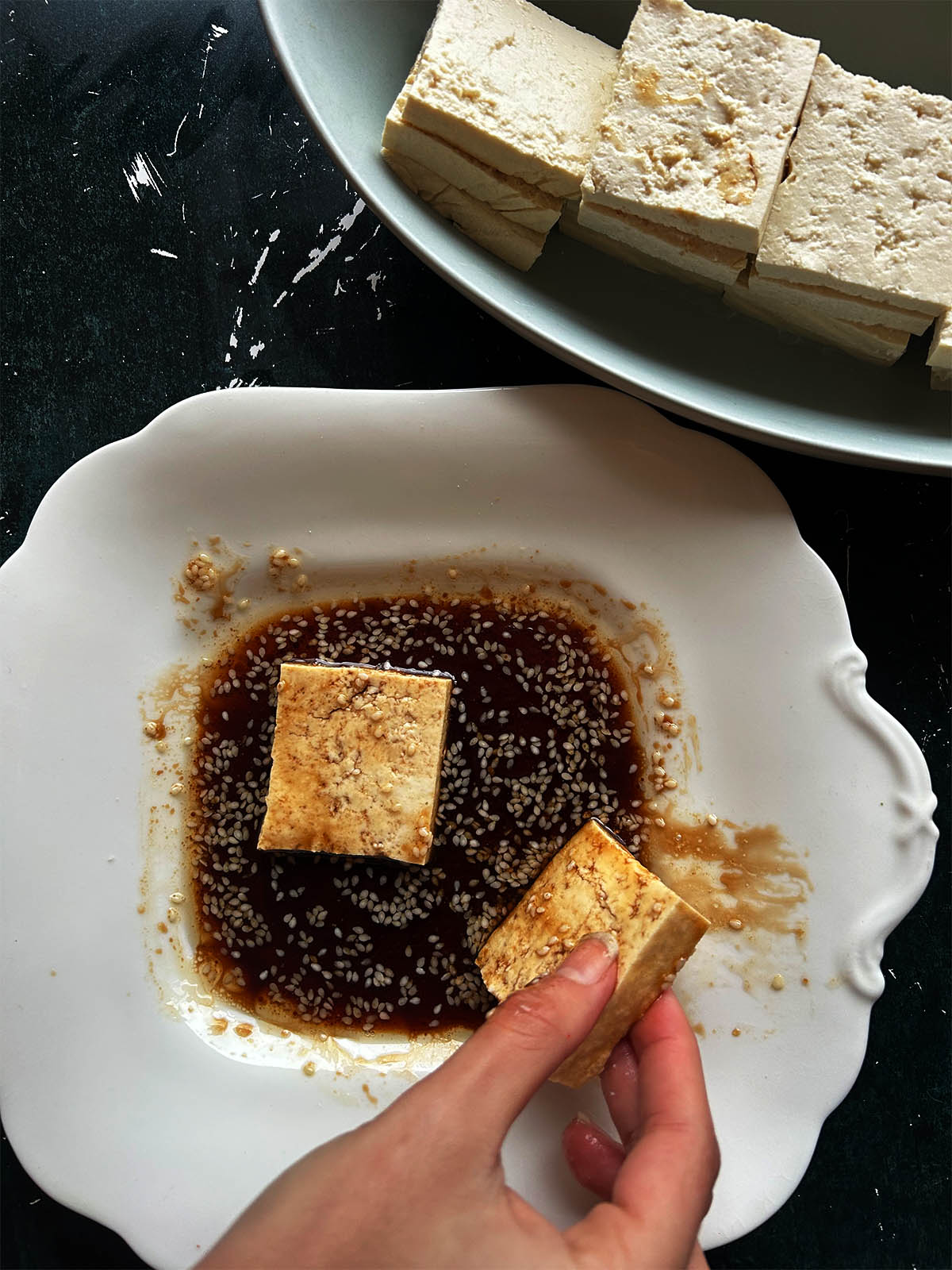 Marinating the tofu.