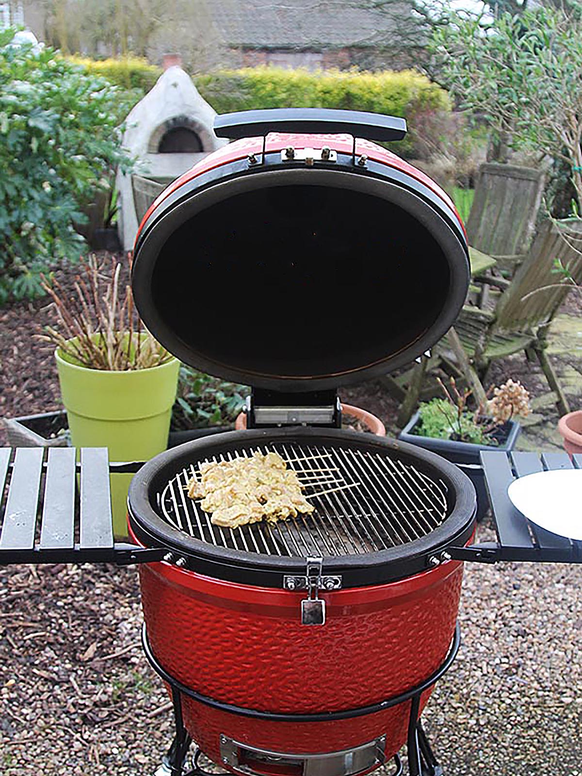 Cooking the chicken skewers on a barbecue.