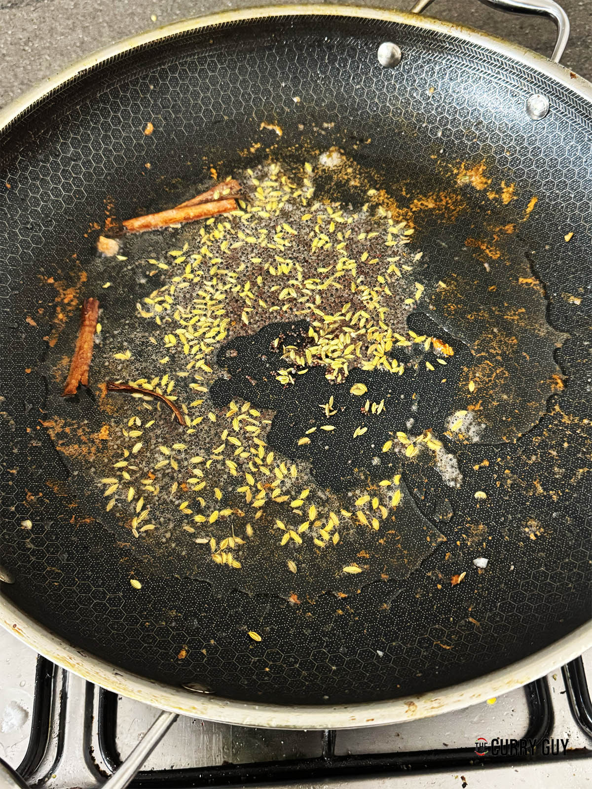 Infusing the whole spices into the oil.