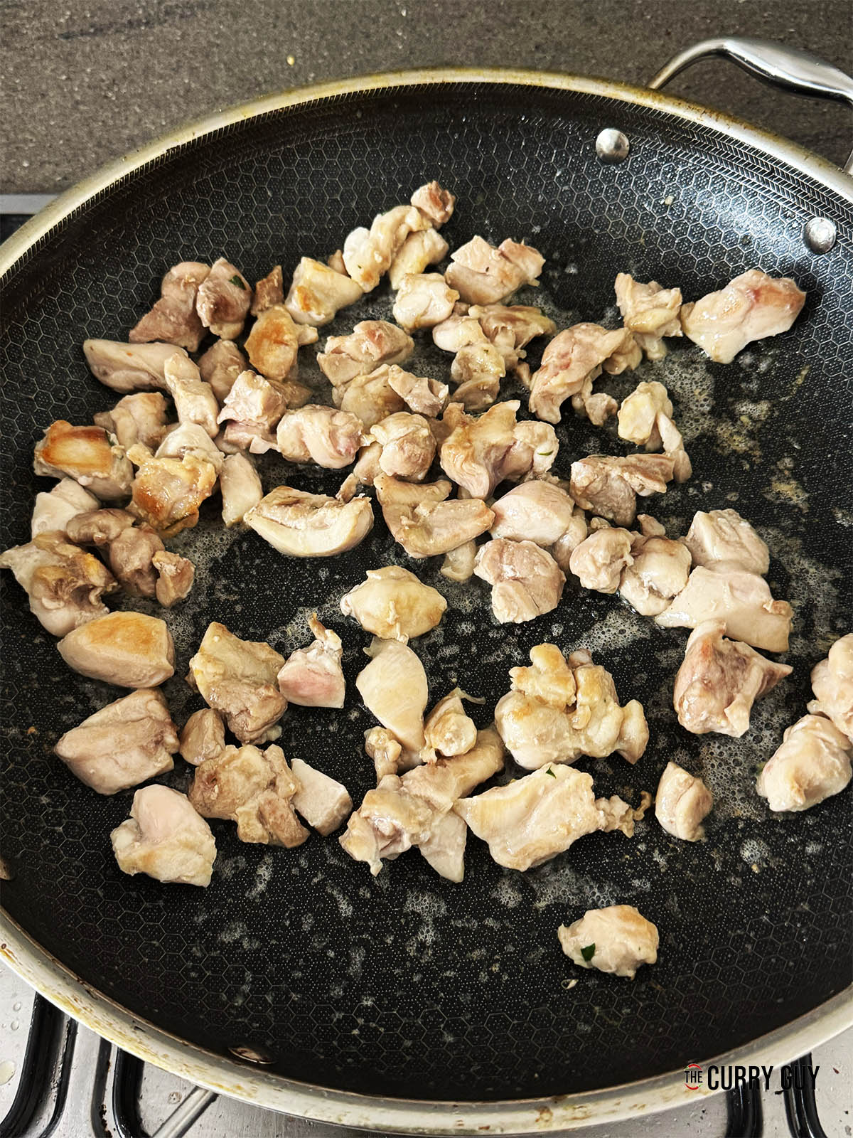 Frying the chicken in a pan.