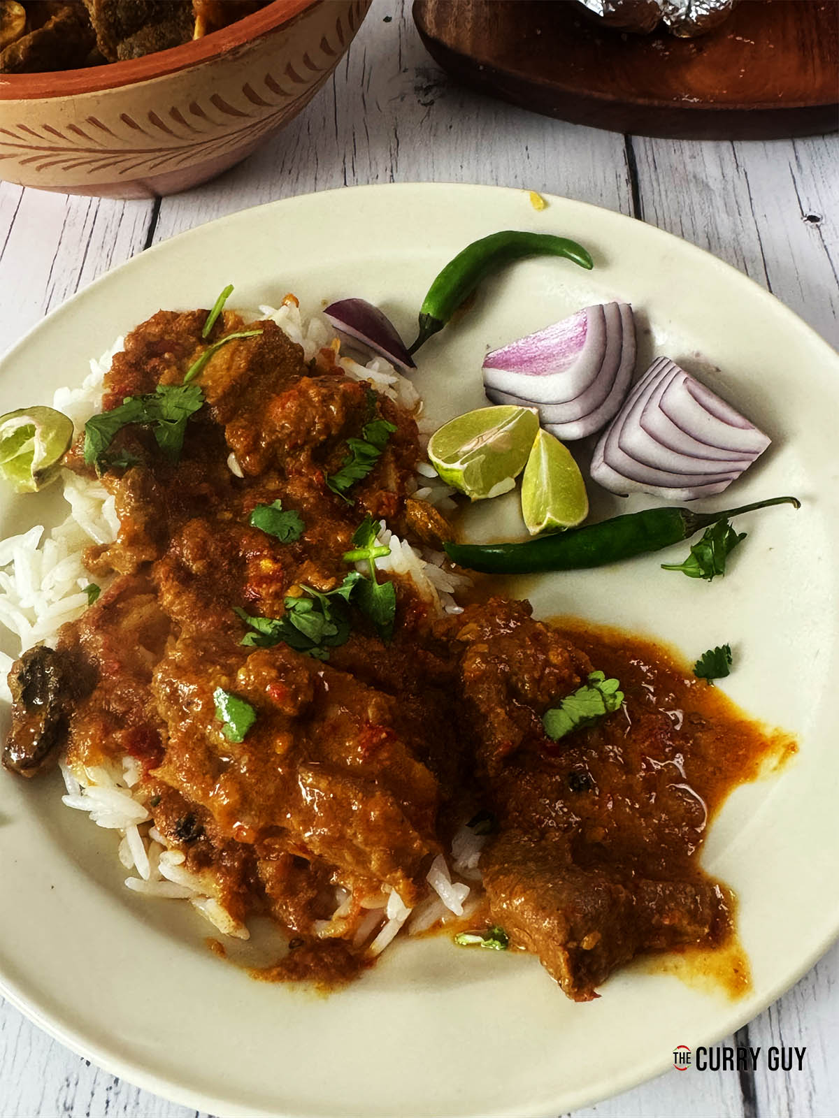 Laal Maas curry on a serving plate with rice.
