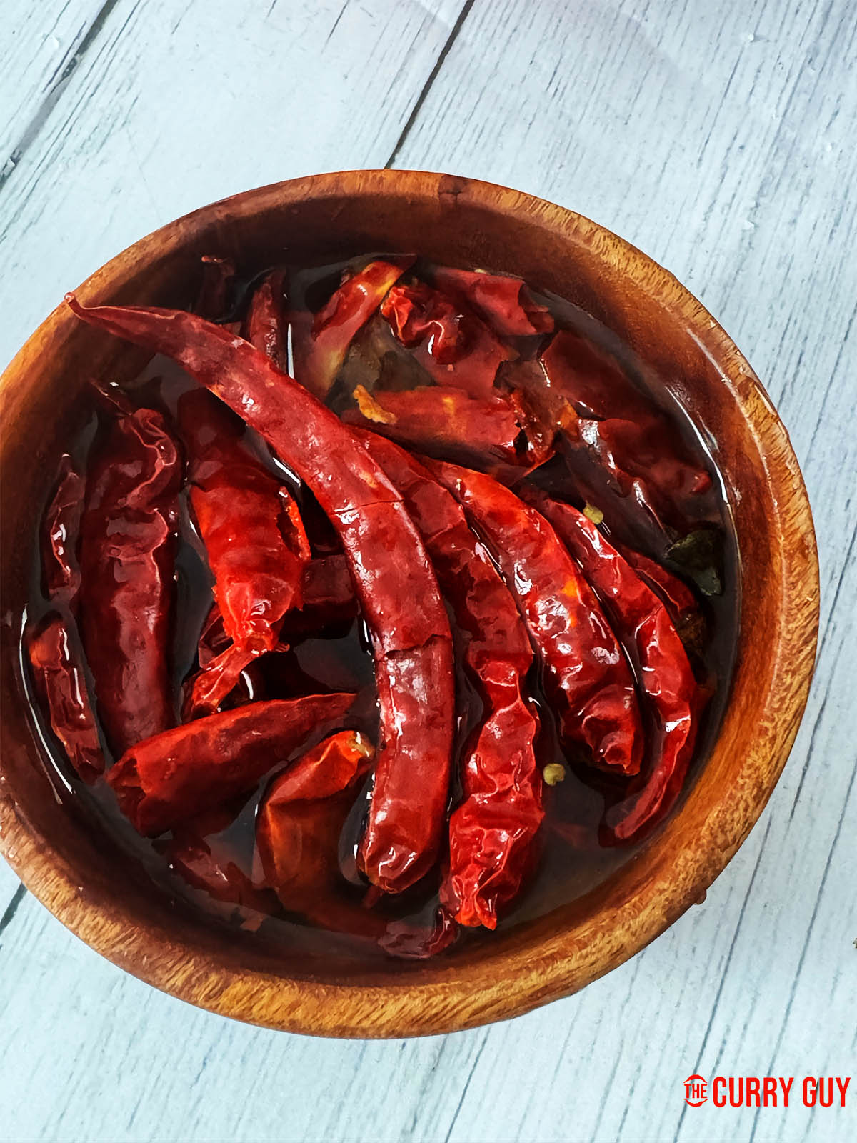 Soaking the Mathania chillies in water for 30 minutes.