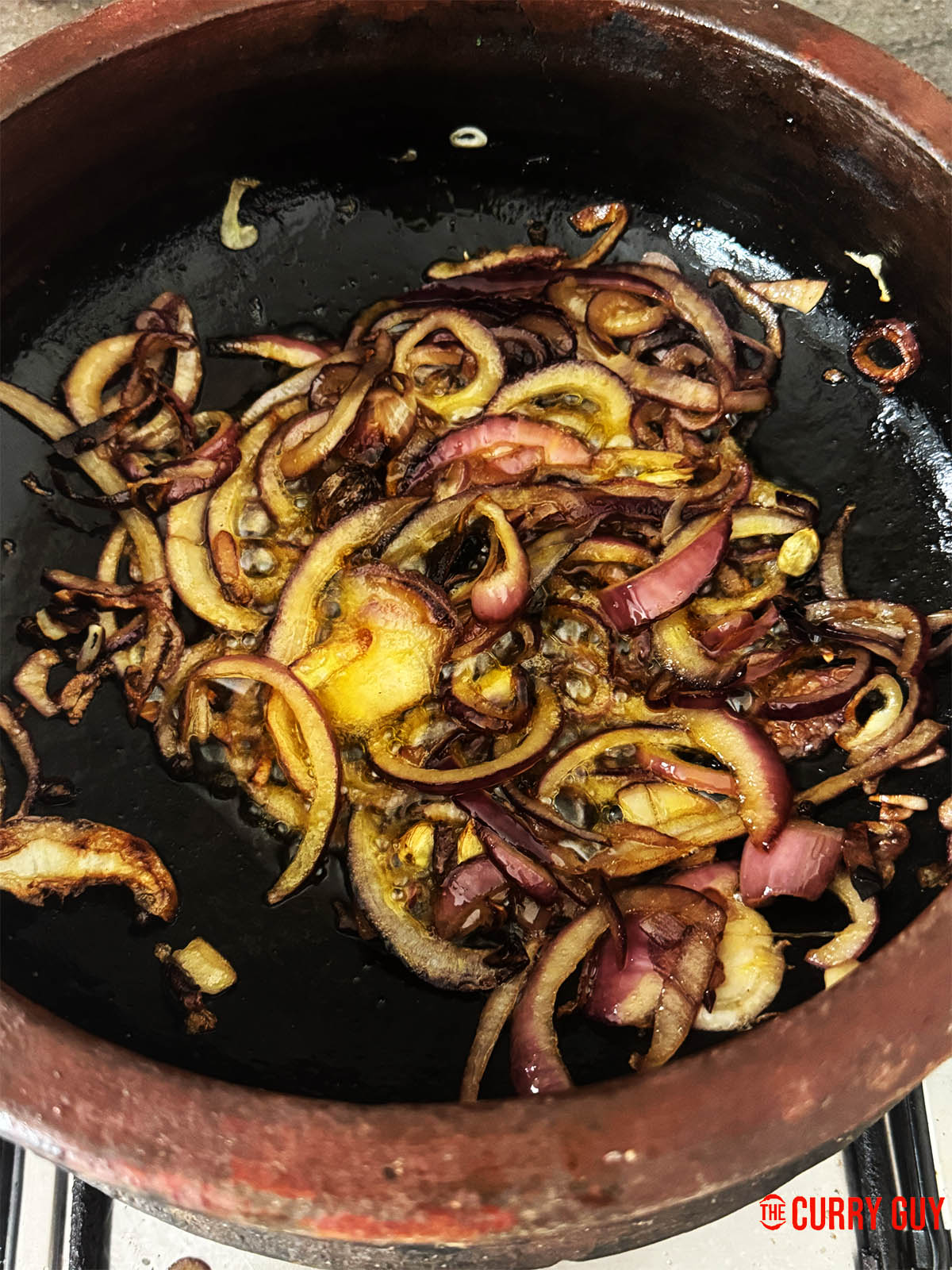 Browning the onions in the flavoured oil and then adding garlic and ginger paste.