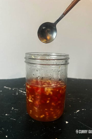 Nuoc cham in a jar after stirring together with a spoon.
