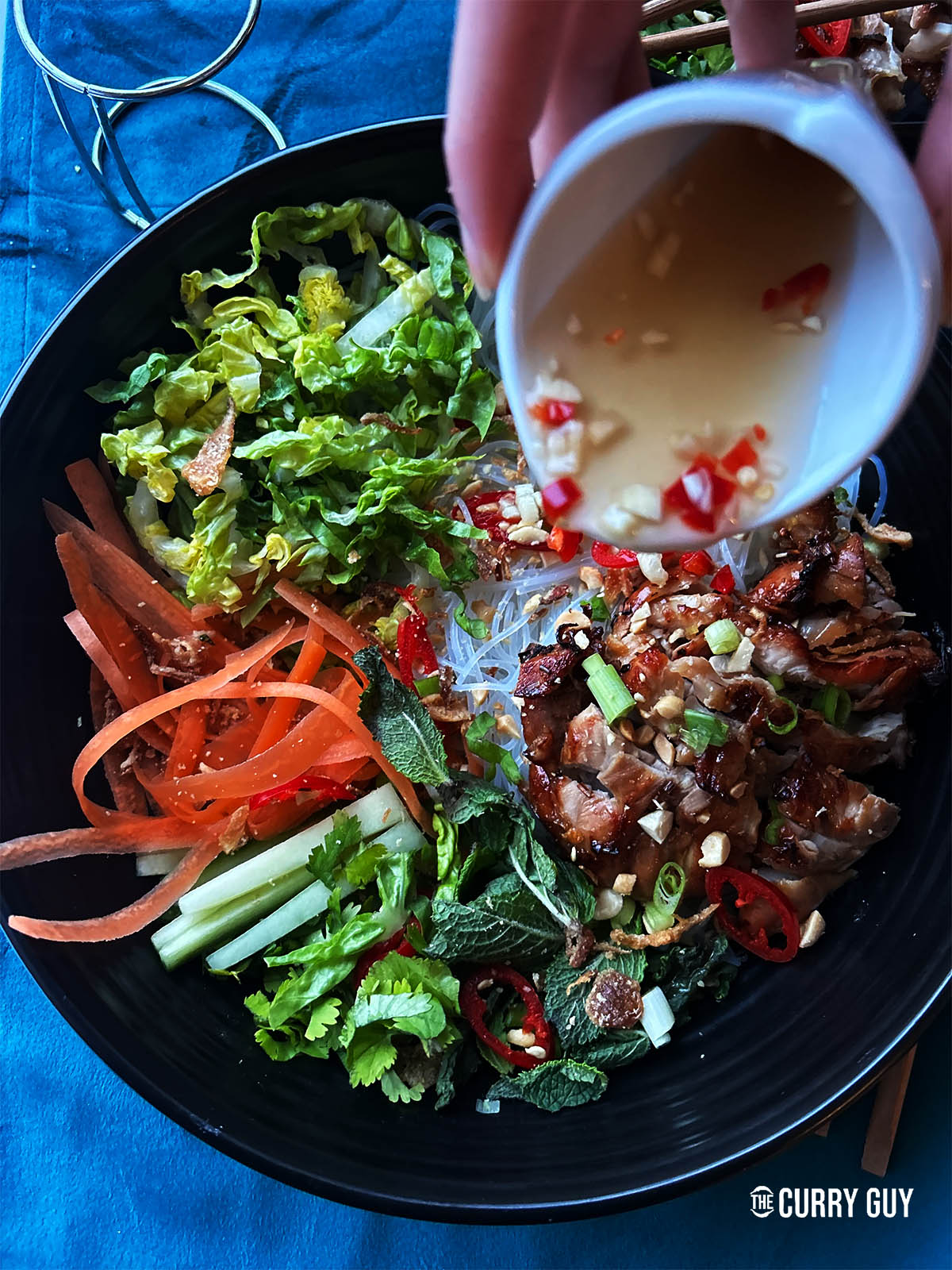 Serving the Nuoc chom over grilled meat, vegetables and noodles.