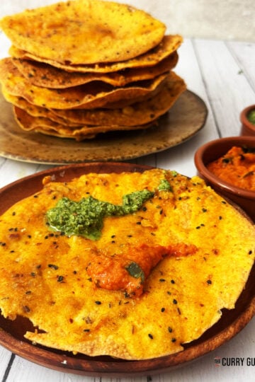 Pappada vada on a serving plate with chutneys.