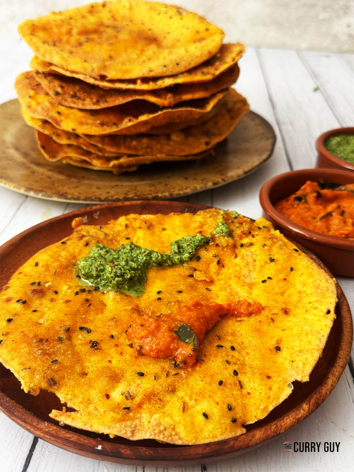 Pappada vada on a serving plate with chutneys.