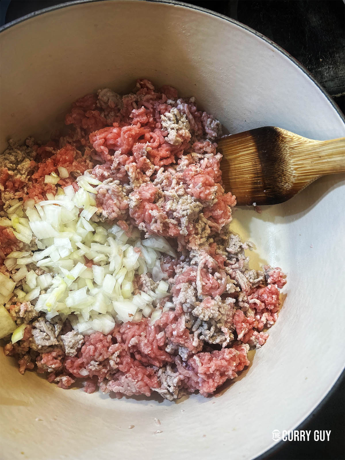 Adding the chopped onion to the pan.