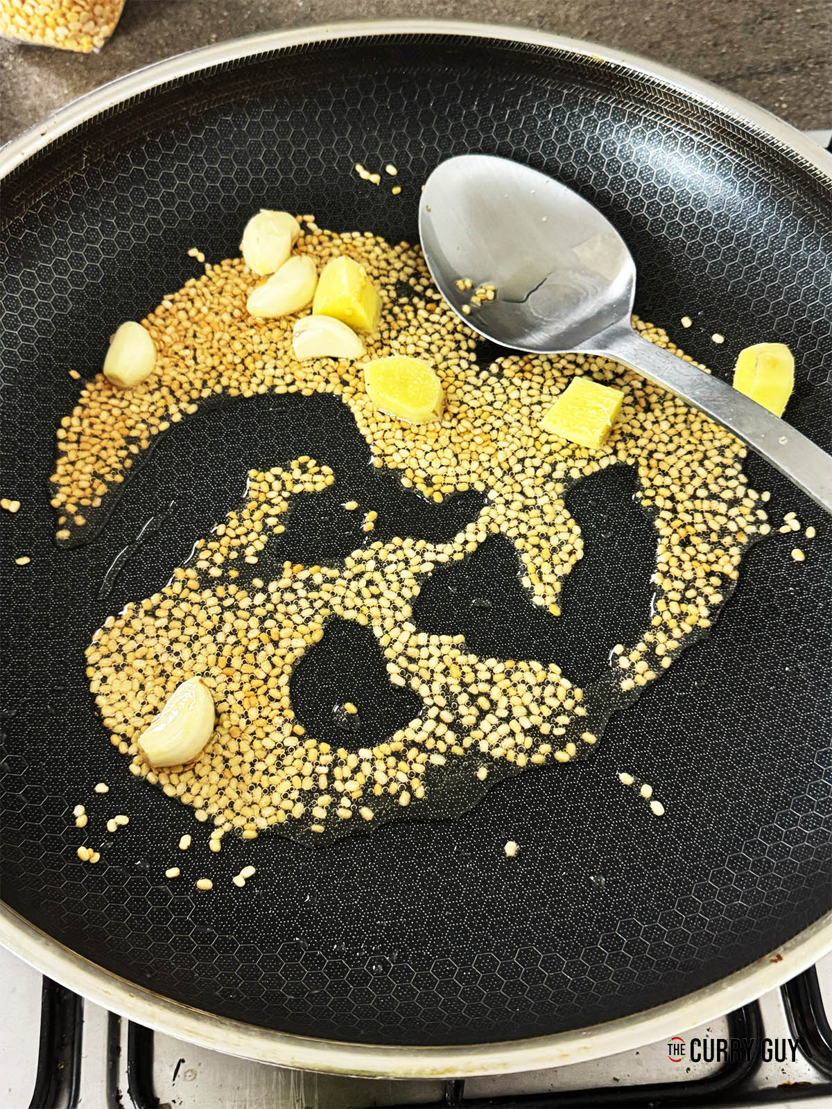 Adding the garlic and ginger to the pan.