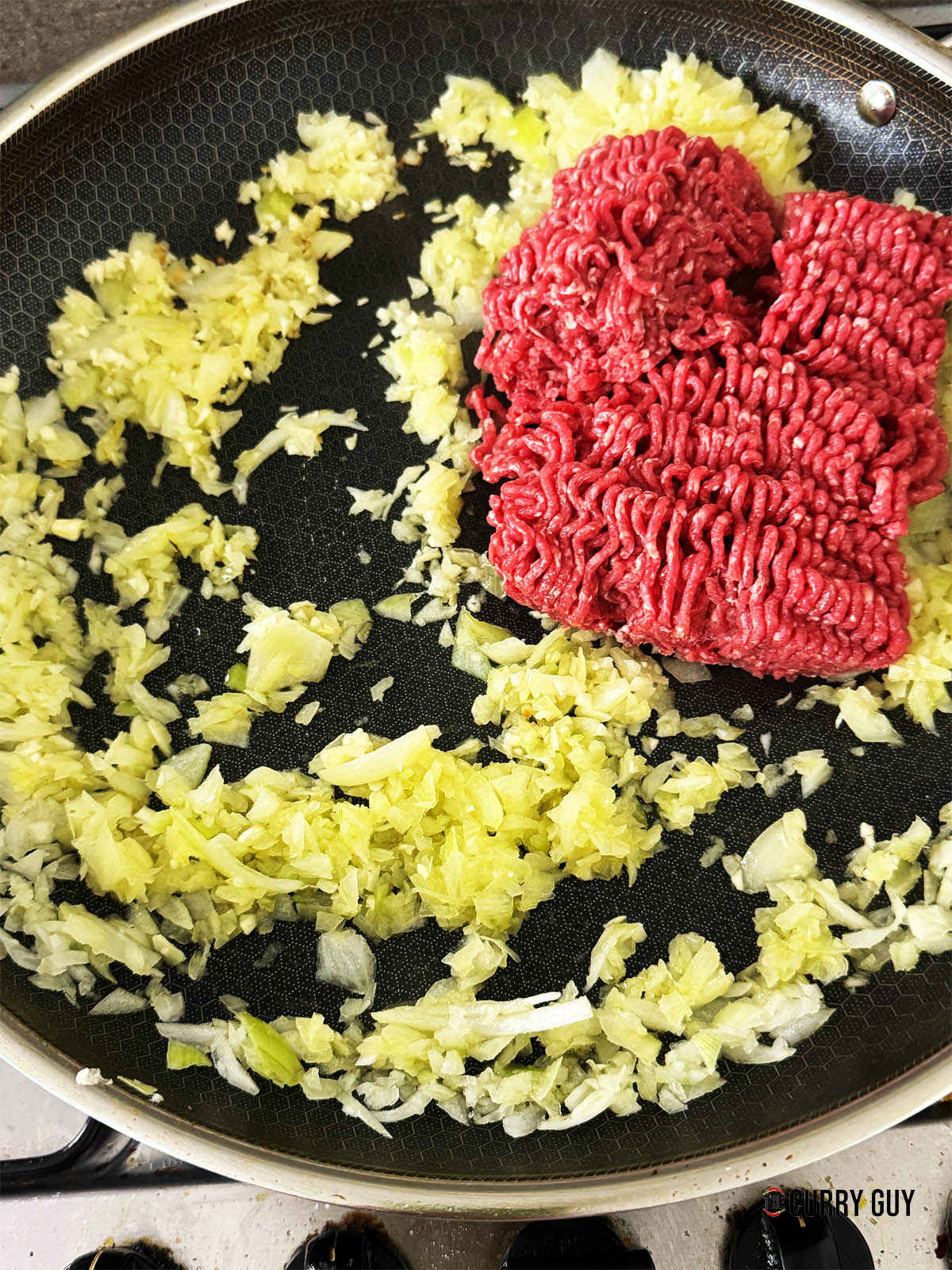 Adding the ground beef to the pan.