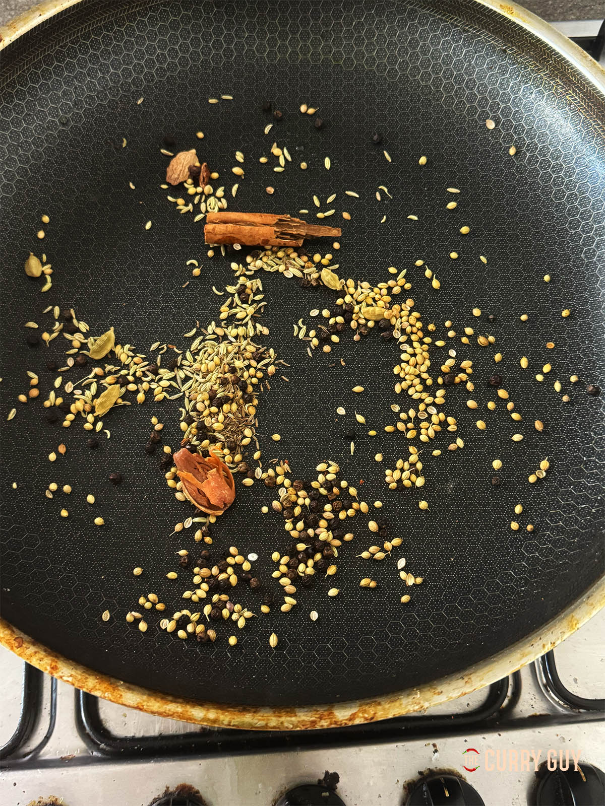 Toasting the whole spices into a pan over a medium heat until fragrant and warm to the touch.