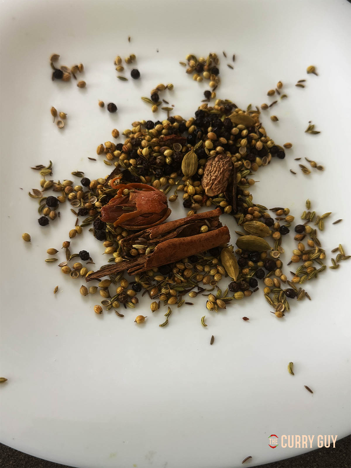 The whole, toasted spices cooking on a plate.