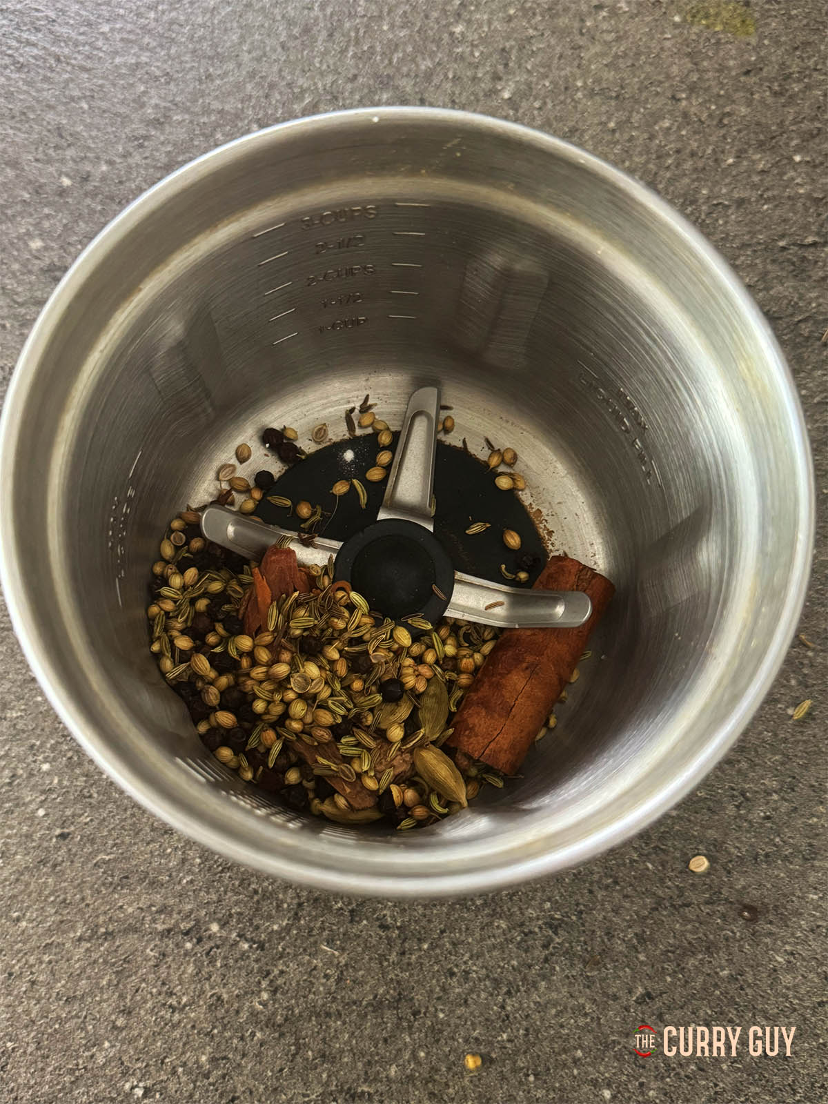 The whole spices in a spice grinder.