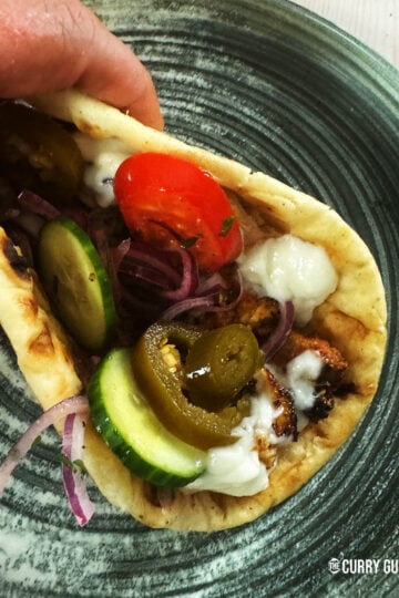 Chicken shawarma wrapped into flat bread with salad vegetables and garlic sauce.