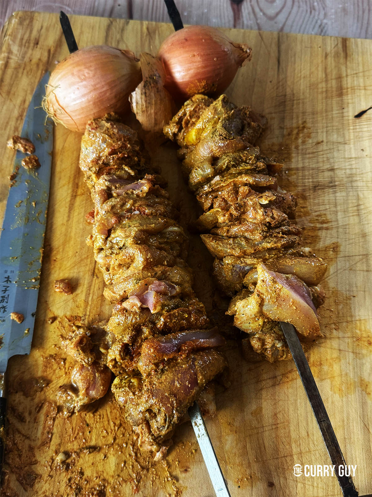 Skewering the chicken tightly onto two skewers.