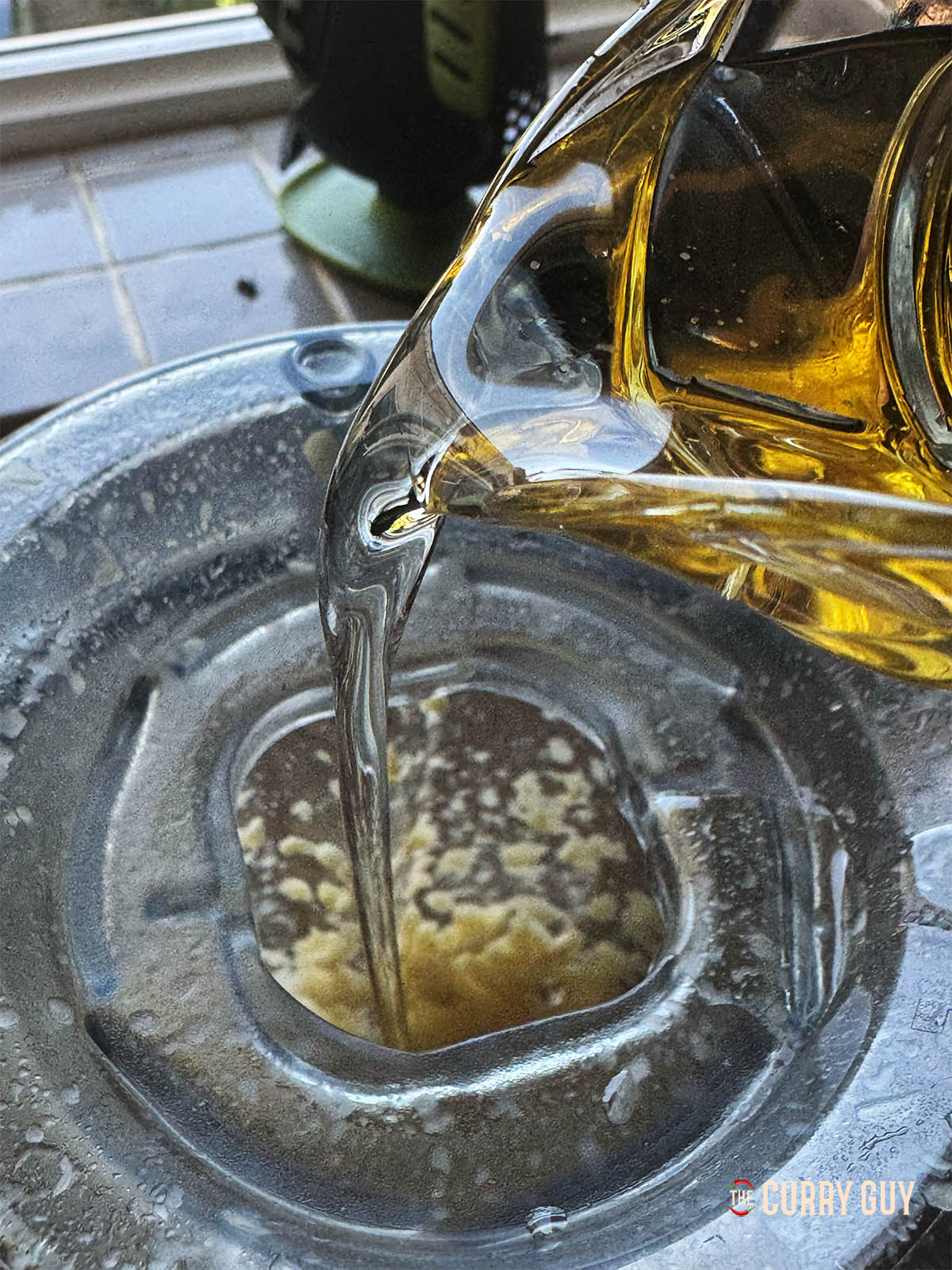 Blending the garlic and salt in a blender using the pulse function and adding a little oil.