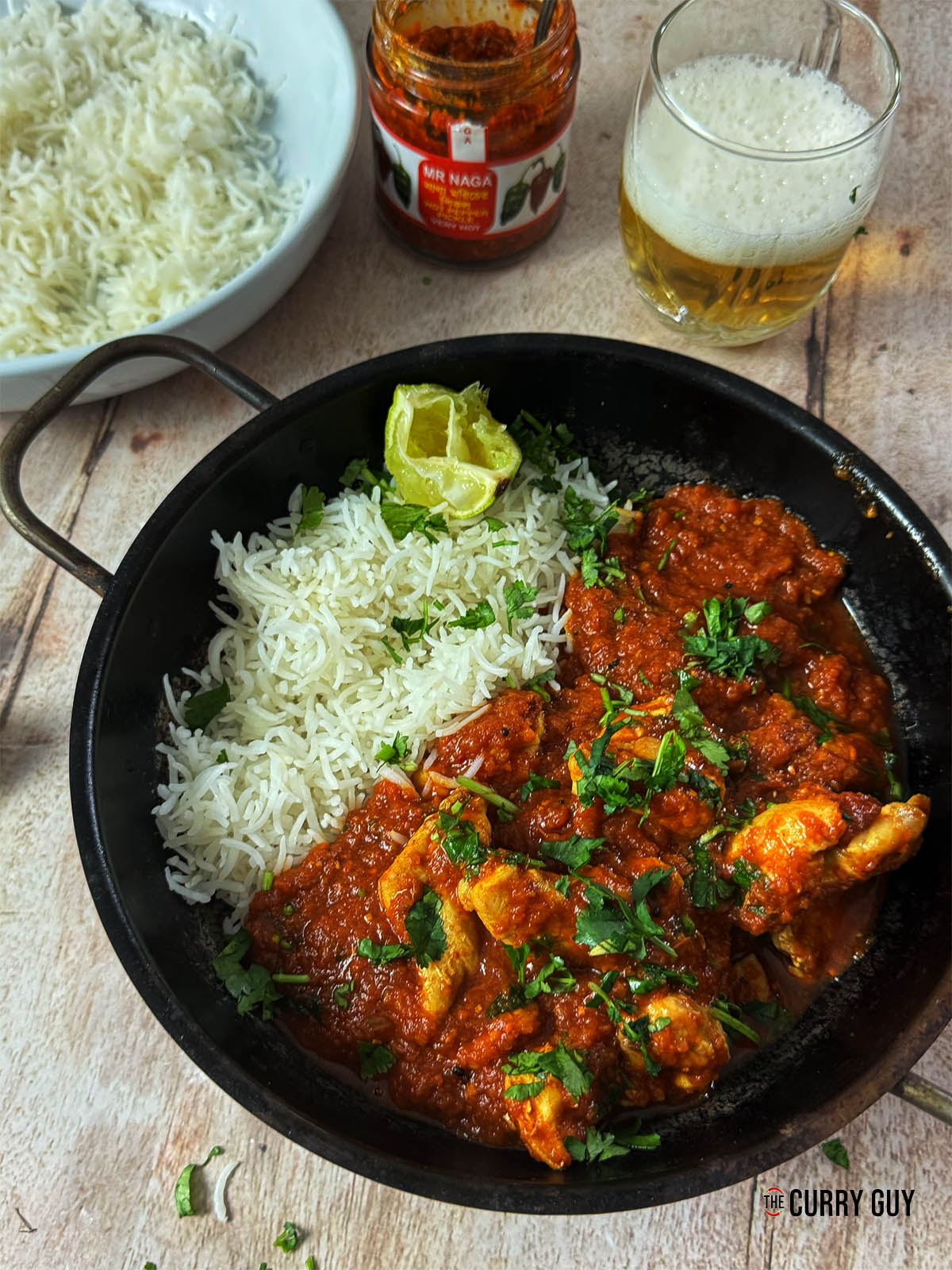 Naga chicken curry in a serving bowl with rice.