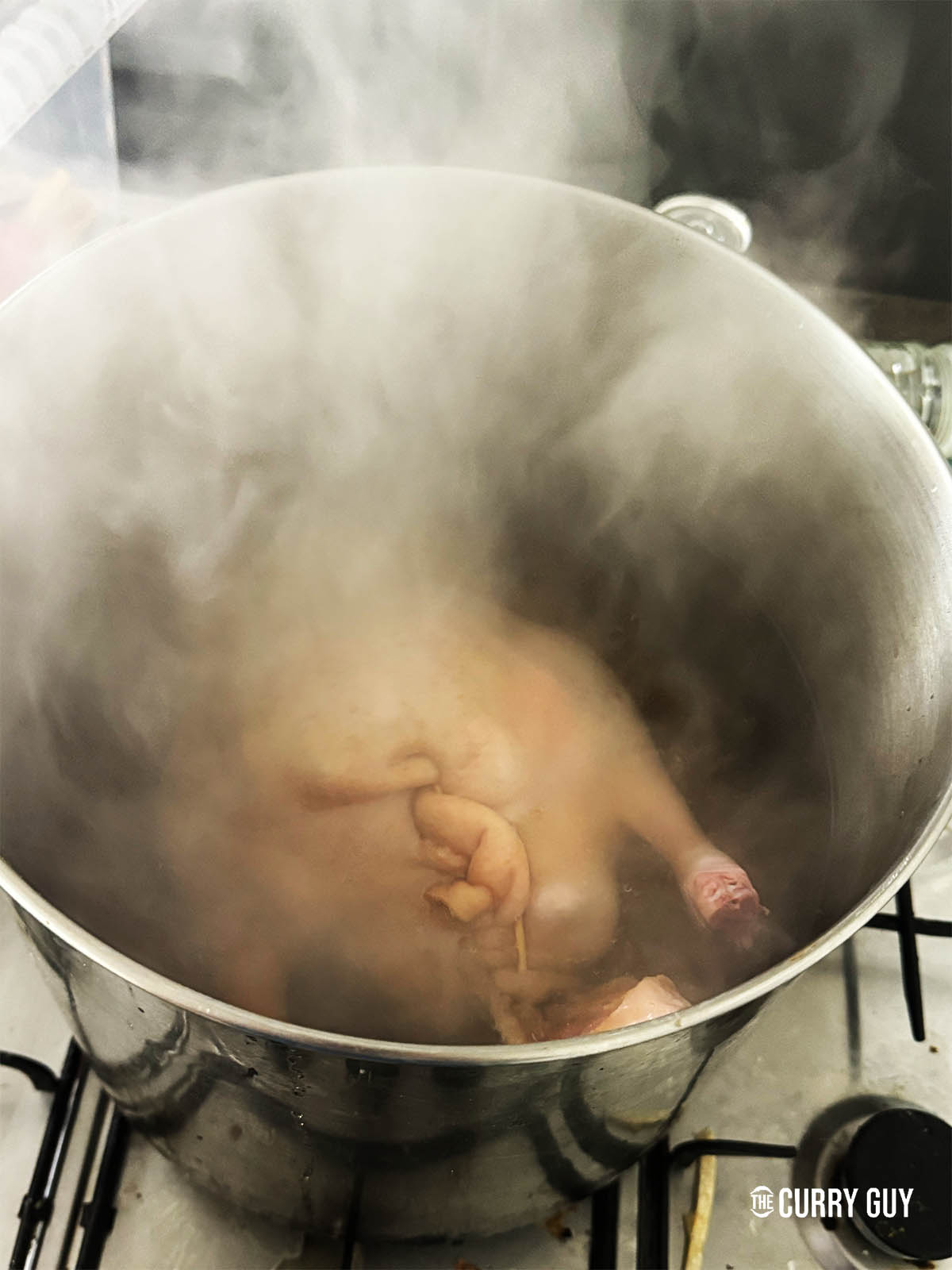 Adding the duck to the pot.