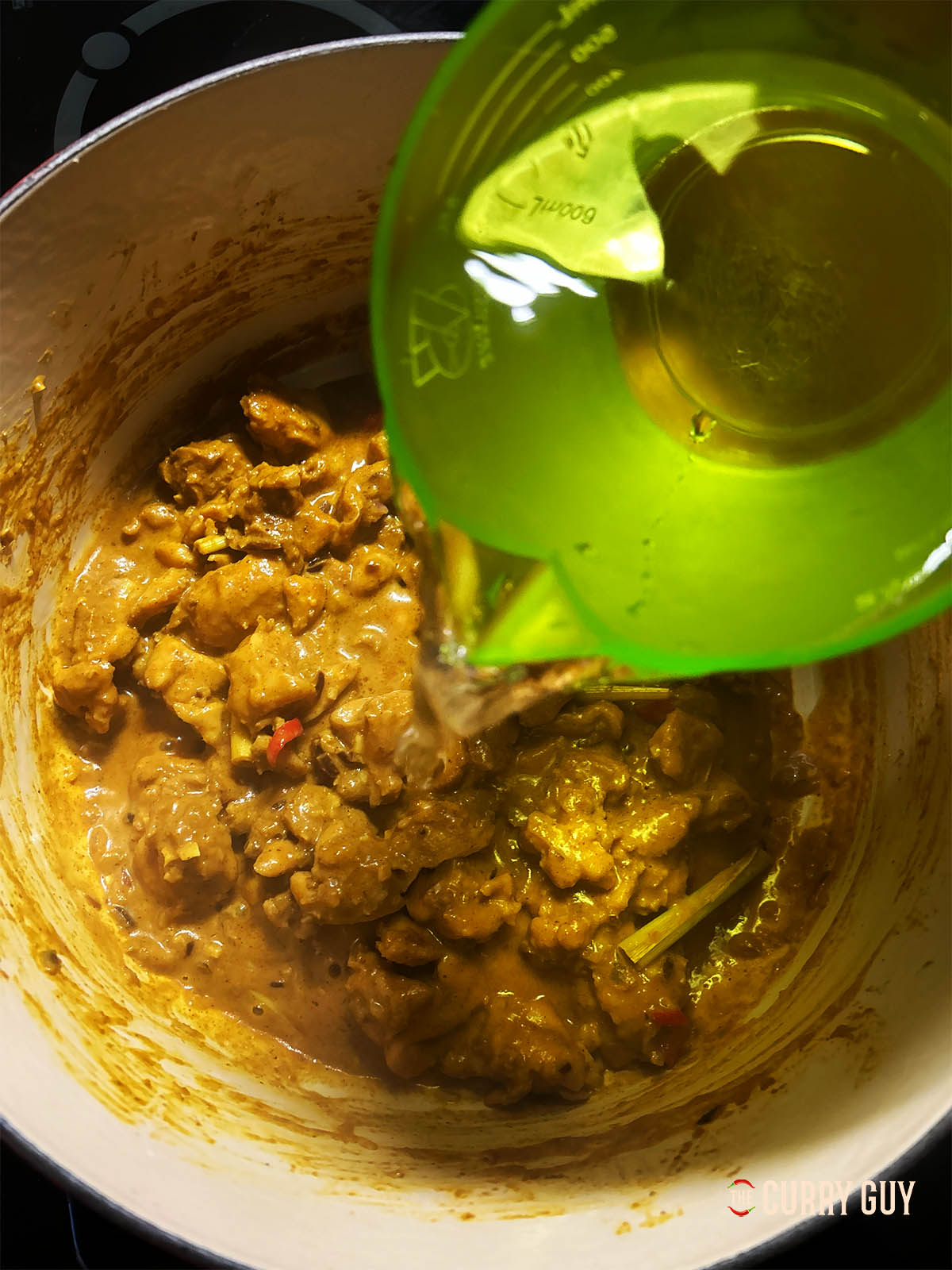 Adding the sweet potato and water to the pot with Chinese chicken stock.