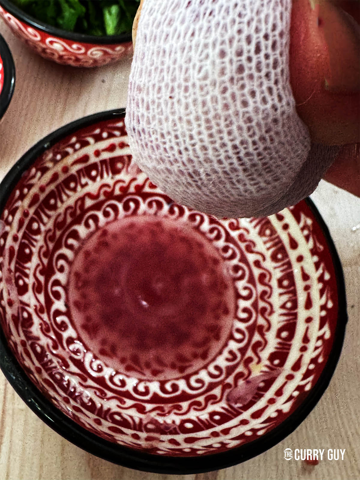 Squeezing the onion juice out of the onion.