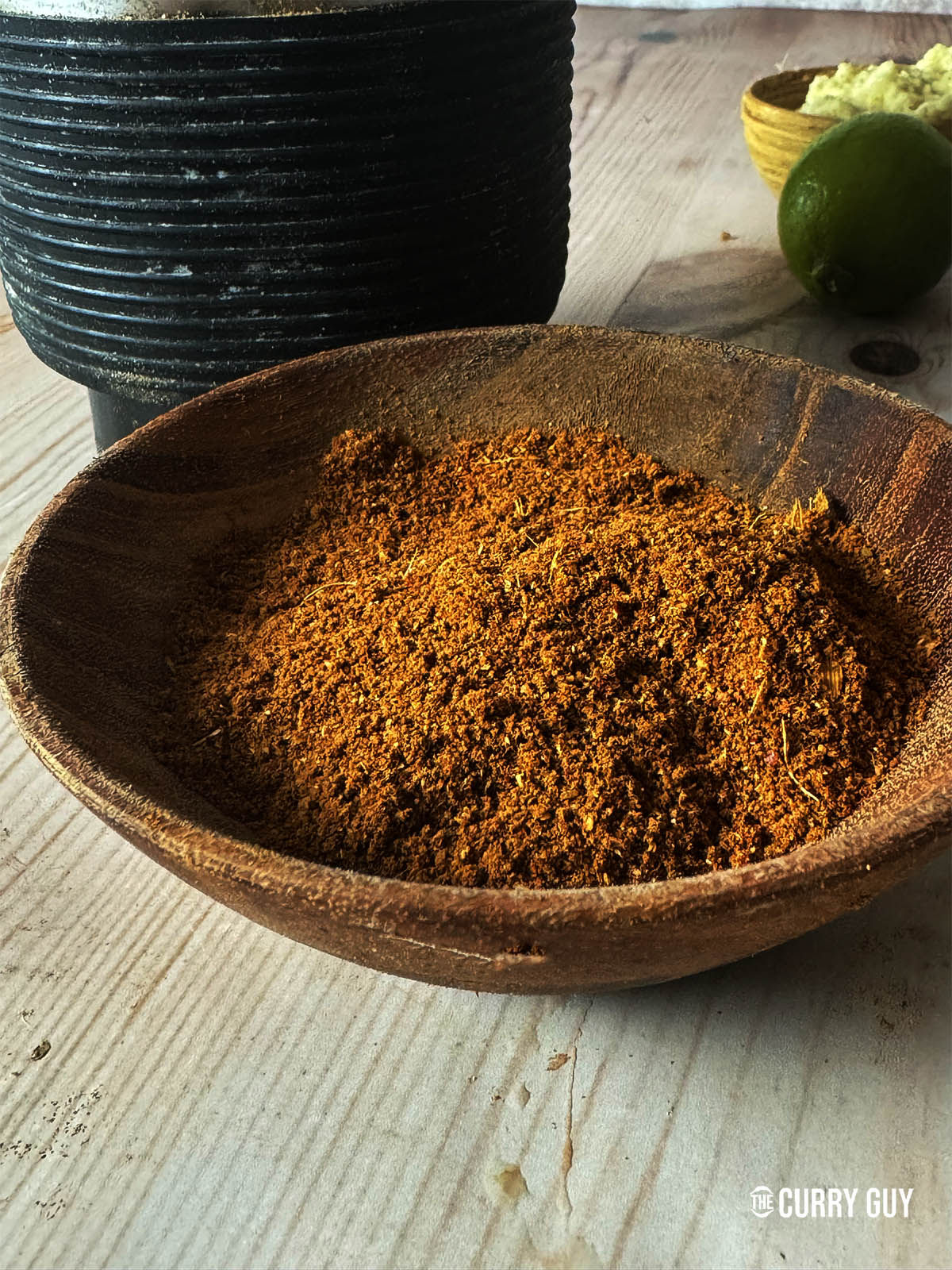 The ground dhansak masala in a wooden bowl.
