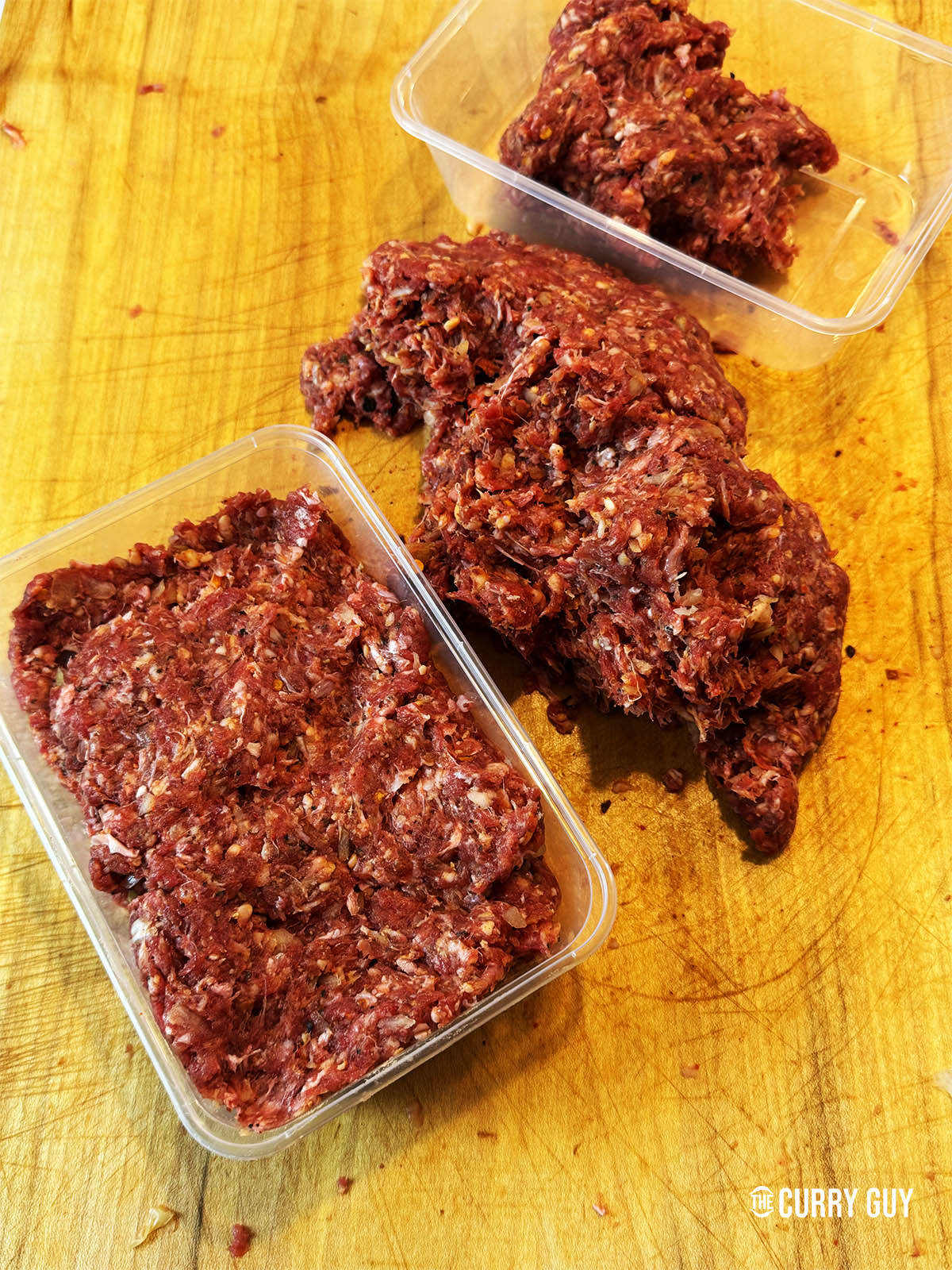 Placing the meat mixture in an airtight container to marinate.