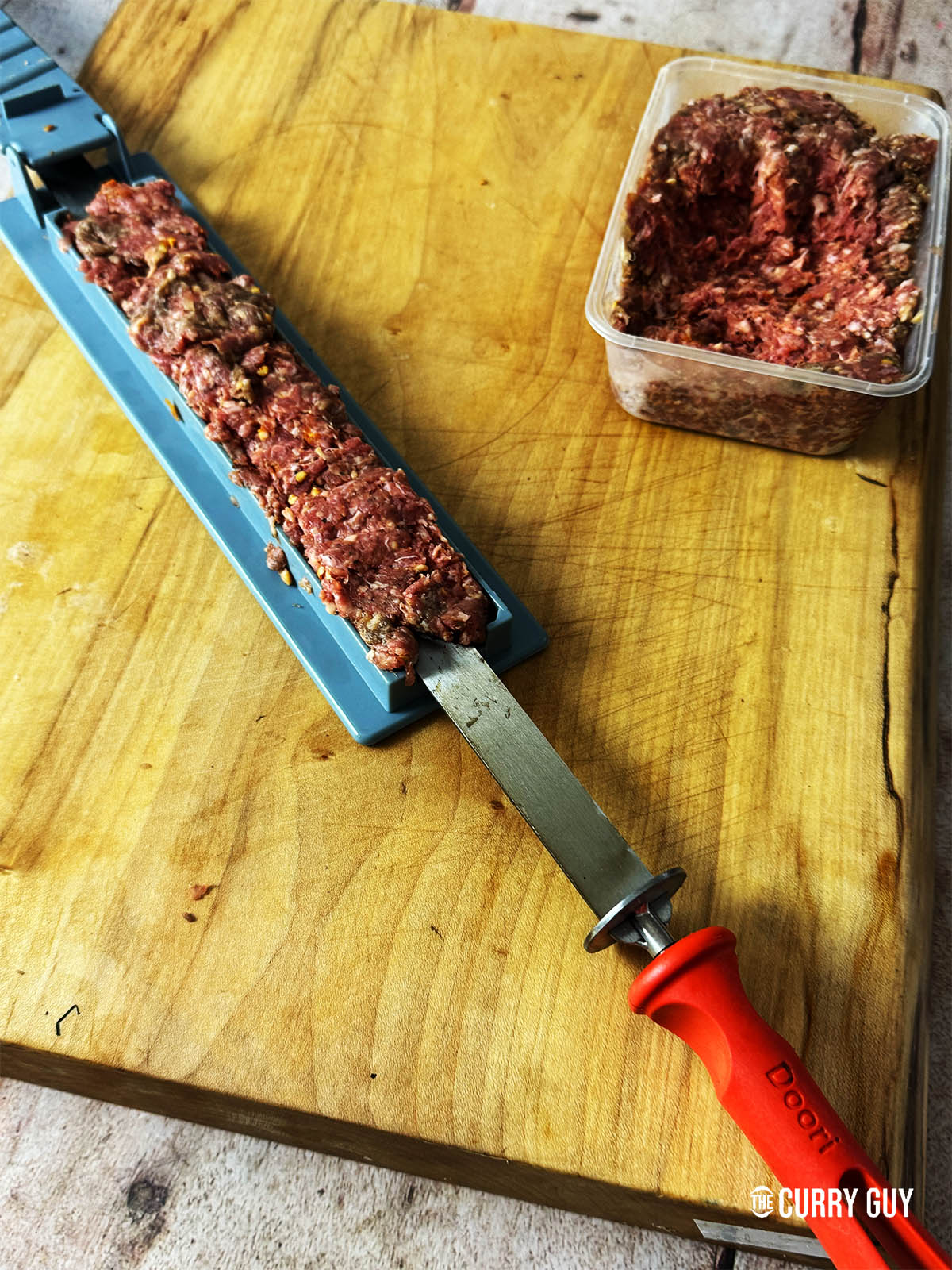 Making a kebab with a kebab mould.