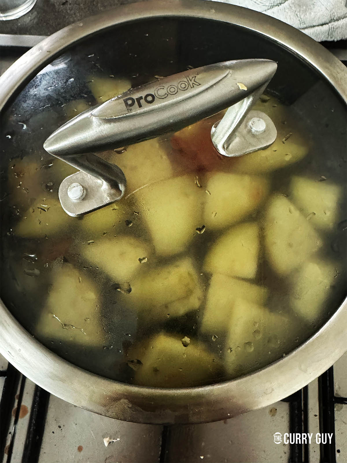 Simmering the dal and vegetables in the pot for 45 minutes.