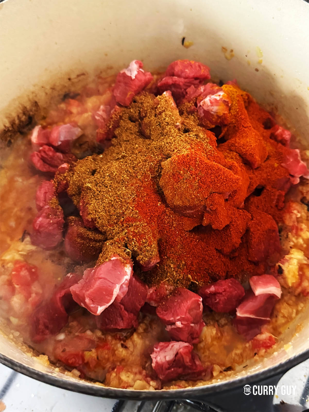 Adding the lamb chunks, chilli powder and dhansak masala.