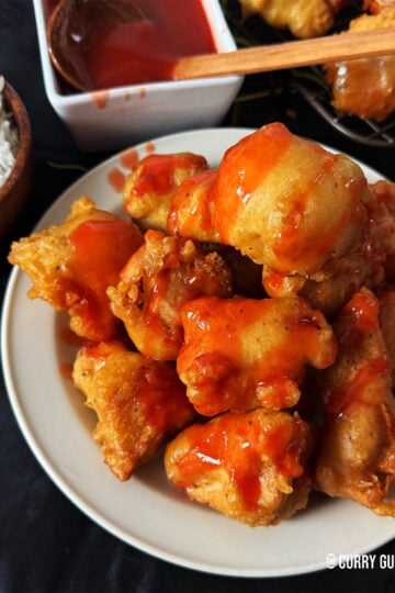 Sweet and sour chicken balls on a serving plate.