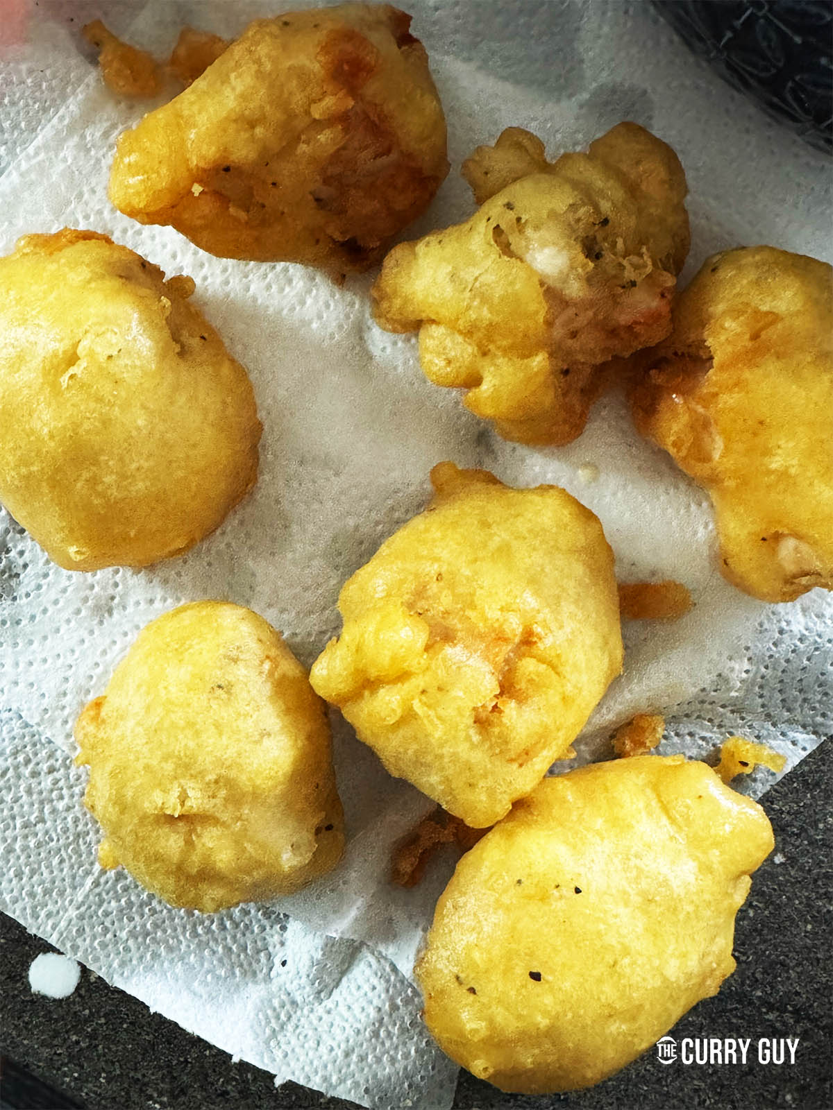 The par-cooked chicken on a paper towel.