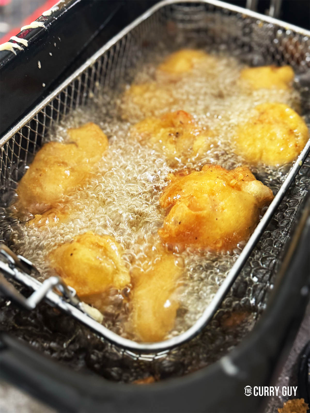 Frying the Chinese chicken balls for a second time to crisp and colour them.