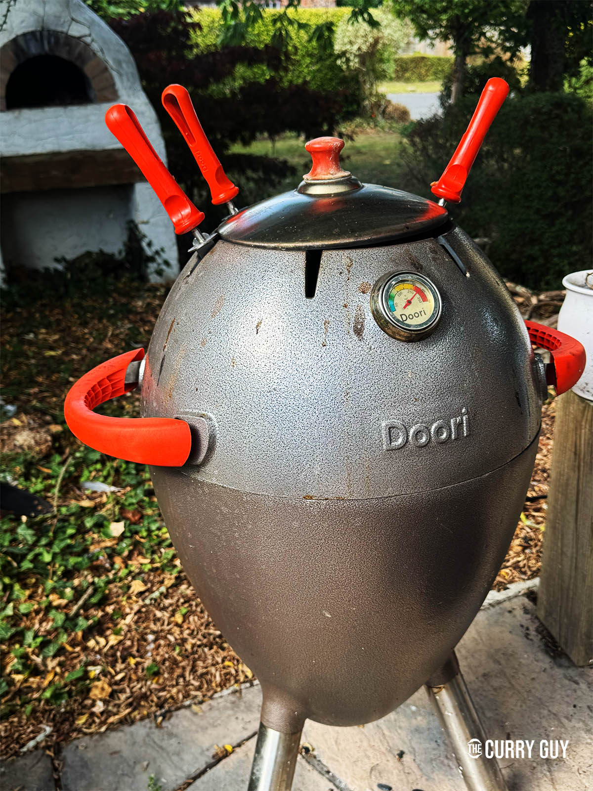 Cooing the roti in a tandoor oven with the lid closed