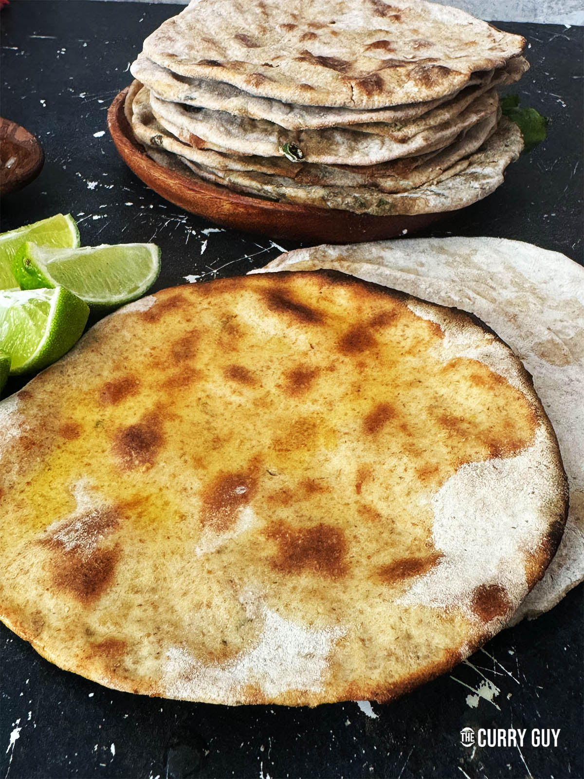 Tandoori roti slathered with ghee to serve.