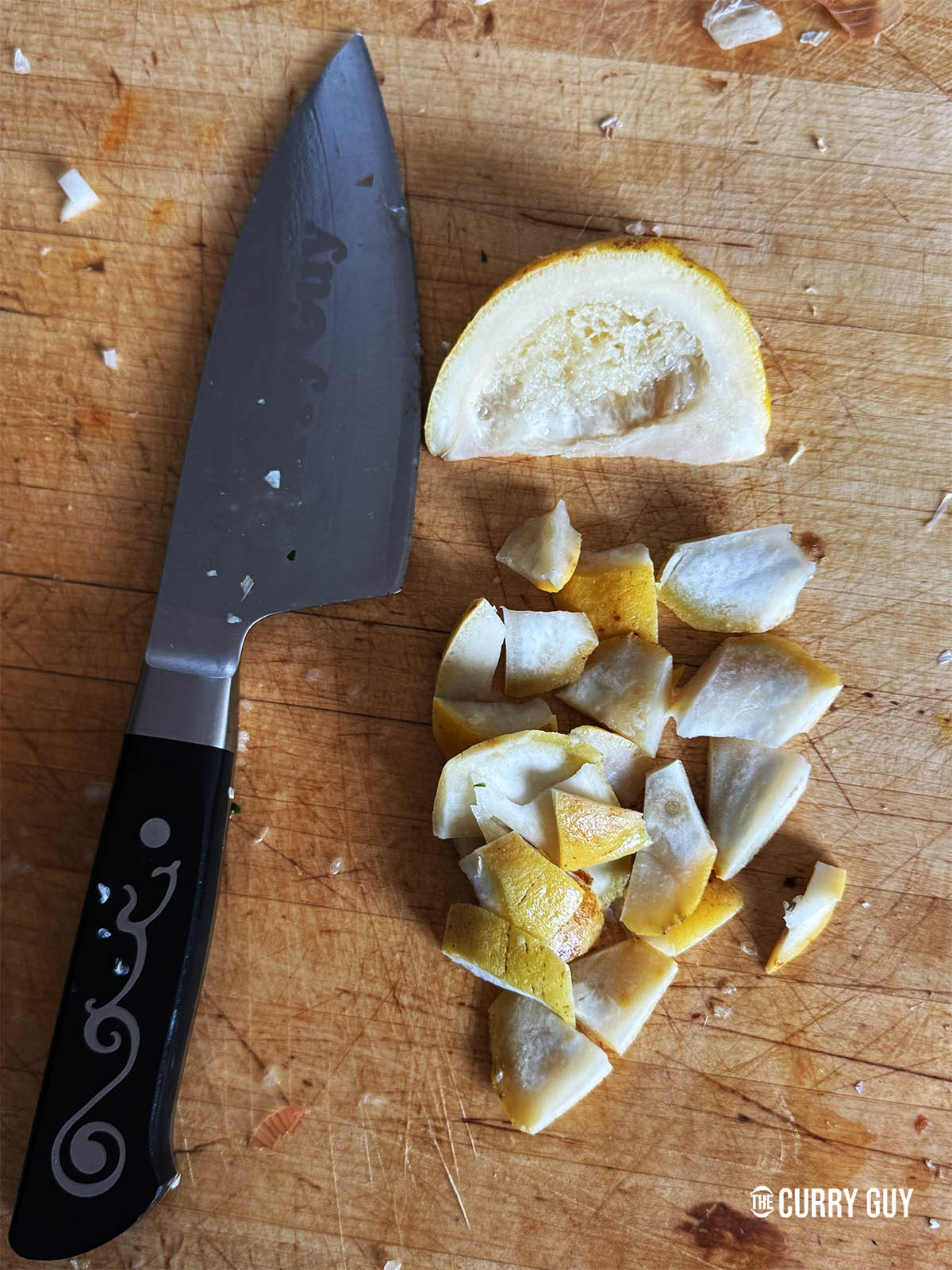 Slicing the rind of the shatkora fruit.