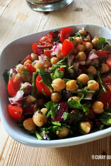 The finished chickpea salad mixed with the dressing in a bowl