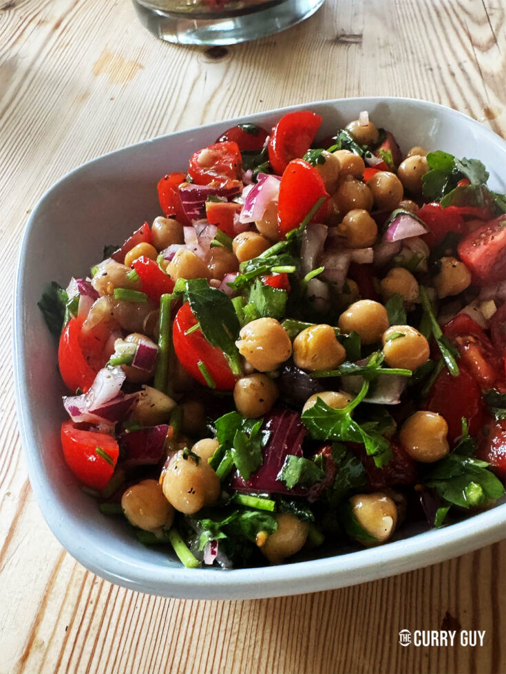 The finished chickpea salad mixed with the dressing in a bowl