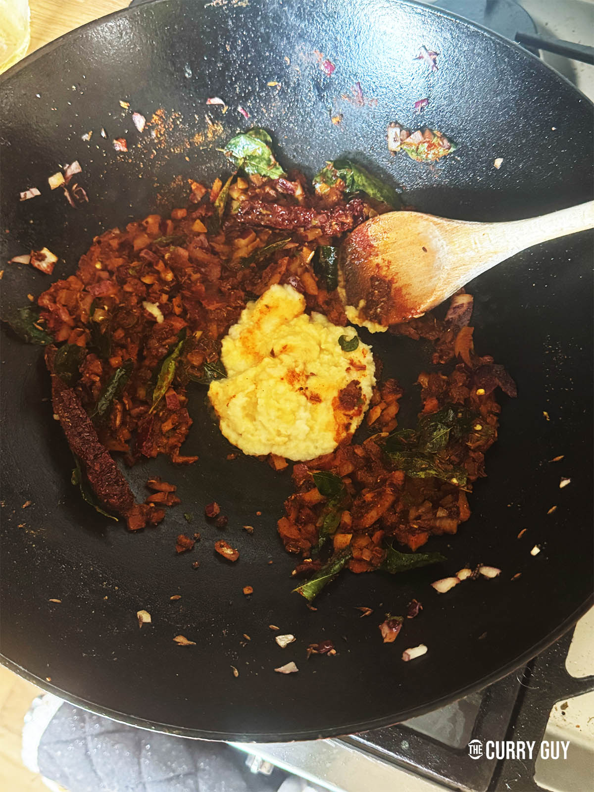 Stirring in the garlic and ginger paste.