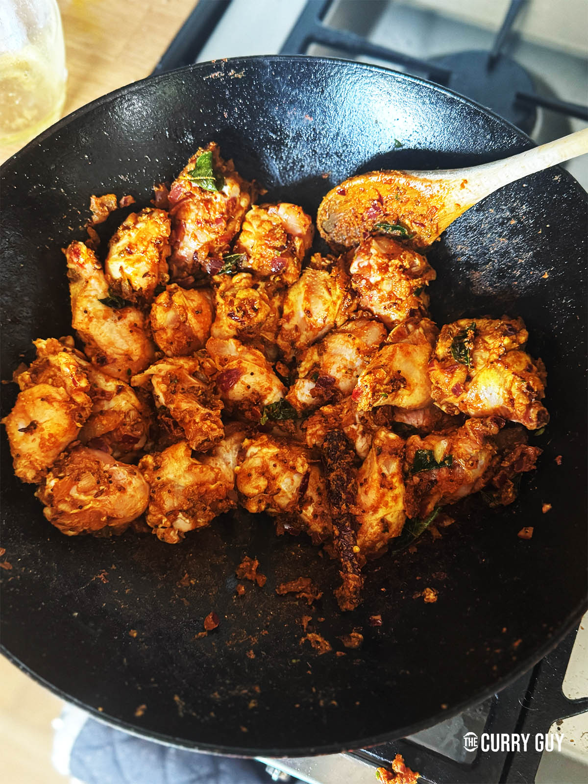 Browning the chicken in the onion and spice mixture.